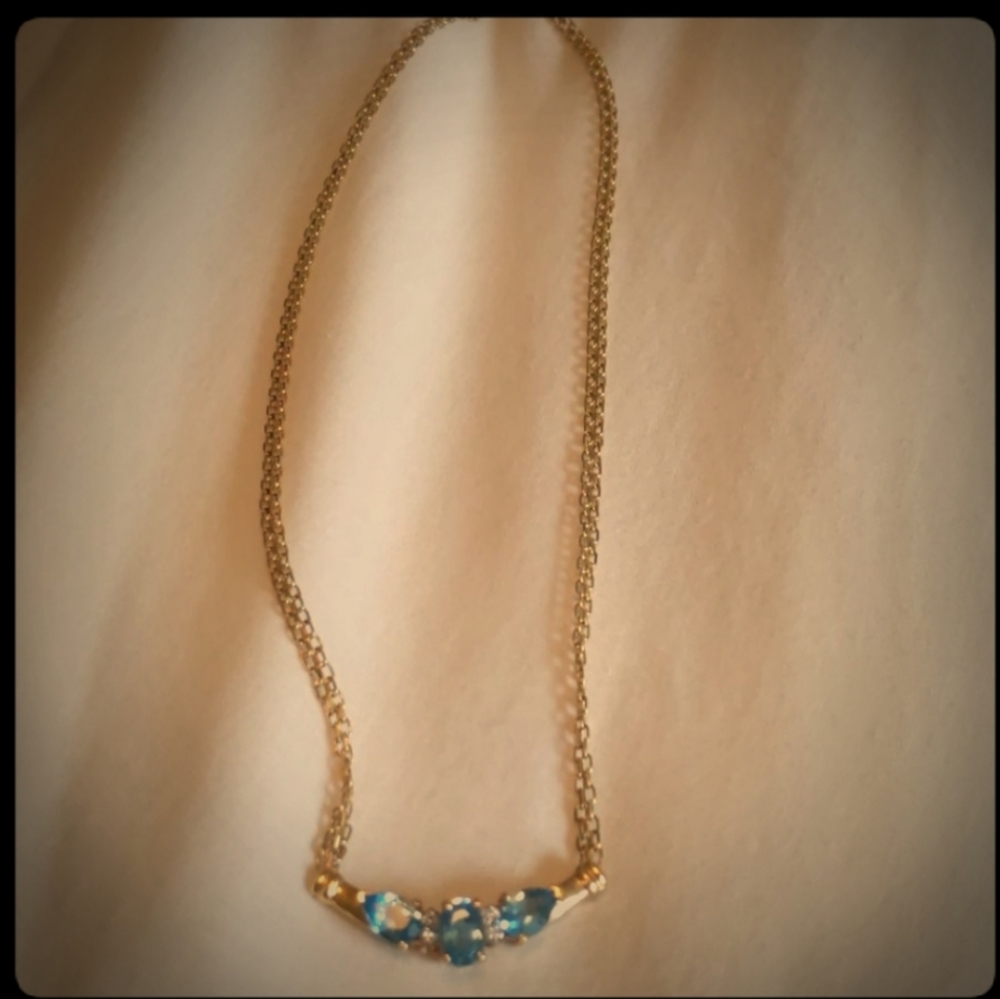 Aquamarine with 14K gold setting.